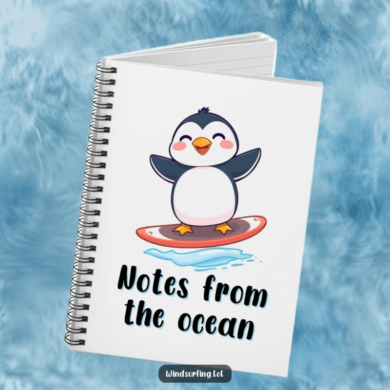 Funny penguin windsurfing notebook with a grinning penguin expertly balancing on a windsurfing board.
