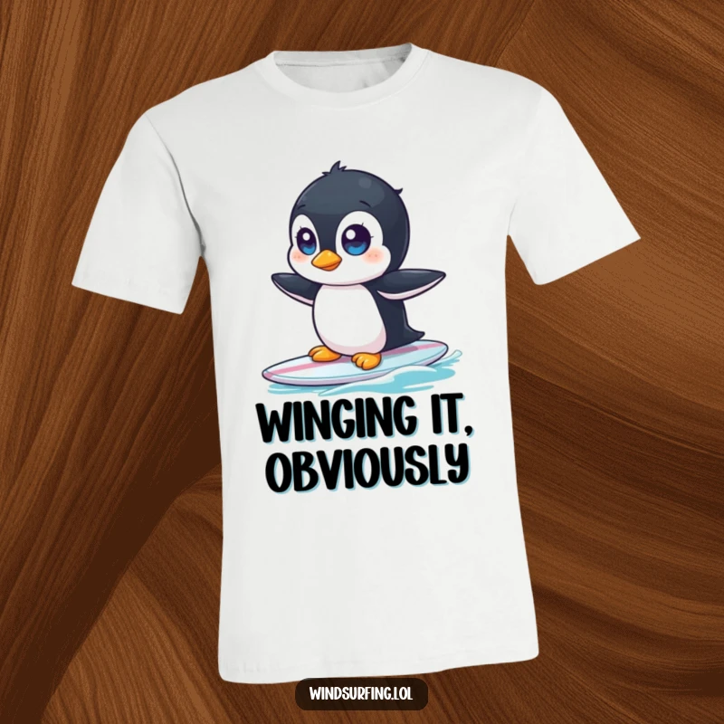 Funny t-shirt featuring a wide-eyed, curious penguin comically wobbling on a surfboard, ready for a wipeout.