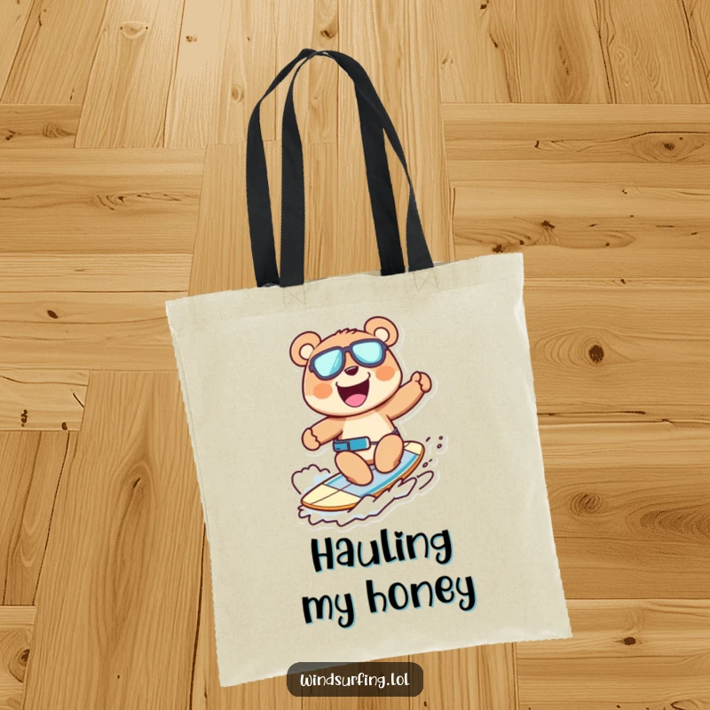 Funny tote bag showcasing a cheerful bear windsurfing with a wide grin, a stylish and humorous accessory.