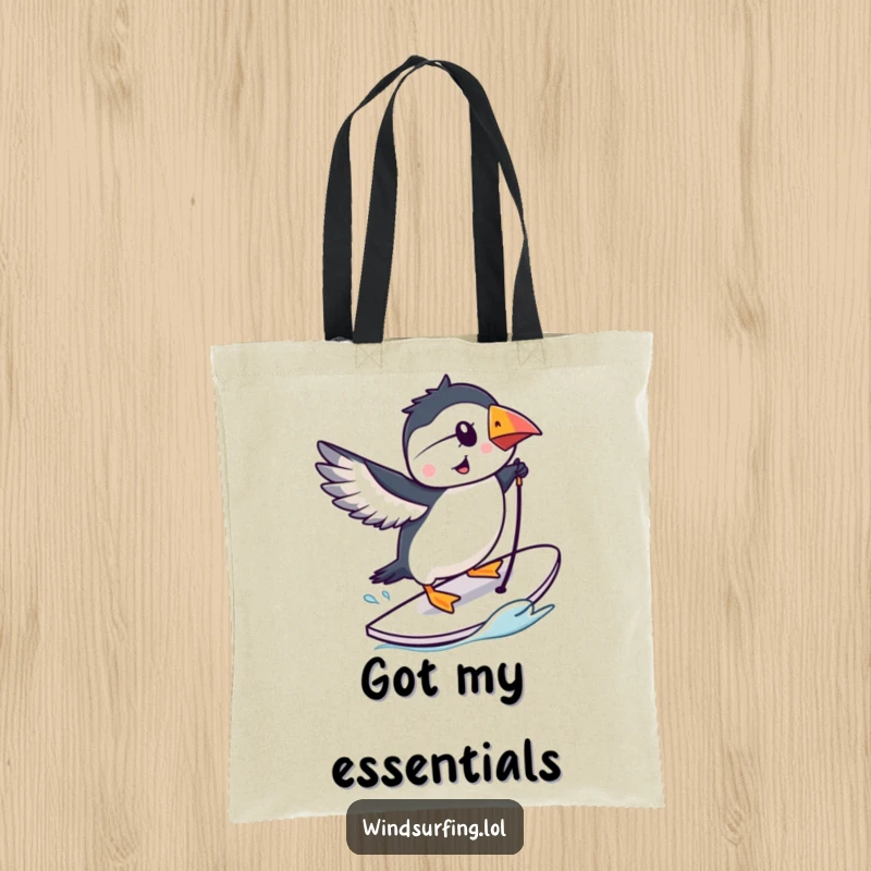 Funny puffin doing a trick on a windsurfing board, cartoon tote bag, bird-themed accessory.