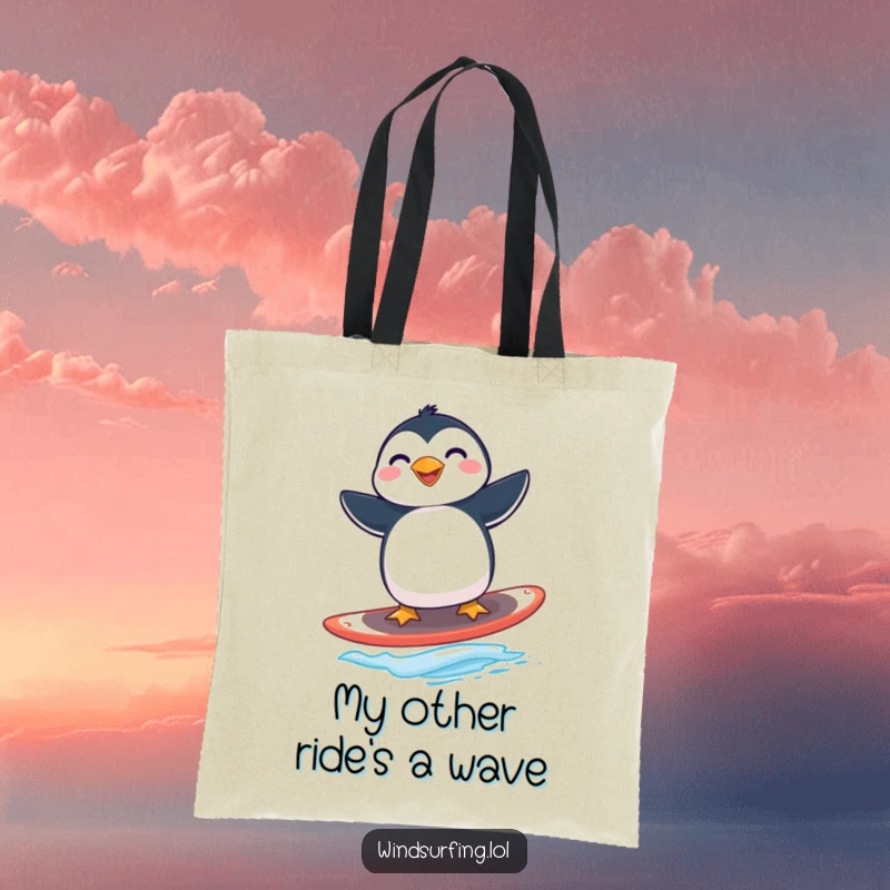 Funny penguin windsurfing tote bag with a grinning penguin expertly riding a windsurfing board.